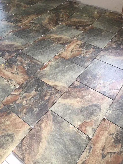 Slate-look porcelain tile floor laid in a staggered pattern