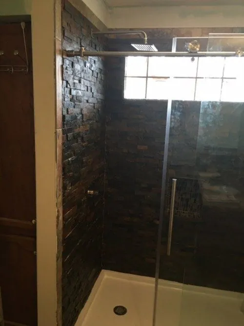 Slate-tile shower with a frameless glass door